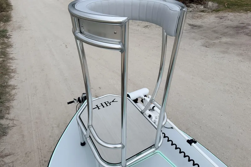 Slide: The Image of 2025 Hell's Bay Professional boat with elevated platform on a sandy path. - 29