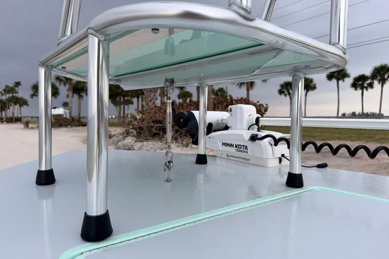 Slide: The Image of 2025 Hell's Bay Professional boat with Minn Kota Terrova motor, beach and palm trees in background. - 30