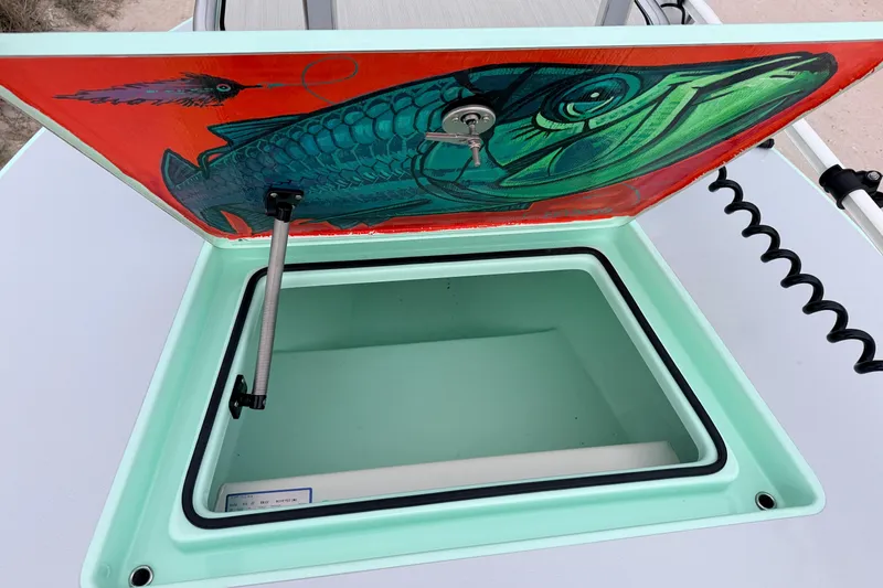 Slide: The Image of Open hatch on 2025 Hell's Bay Professional boat with fish artwork inside. - 34