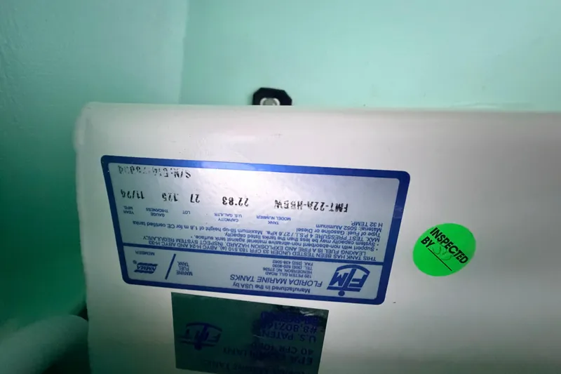 Slide: The Image of Label on Hell's Bay Professional 2025 boat, featuring inspection sticker and specifications. - 37