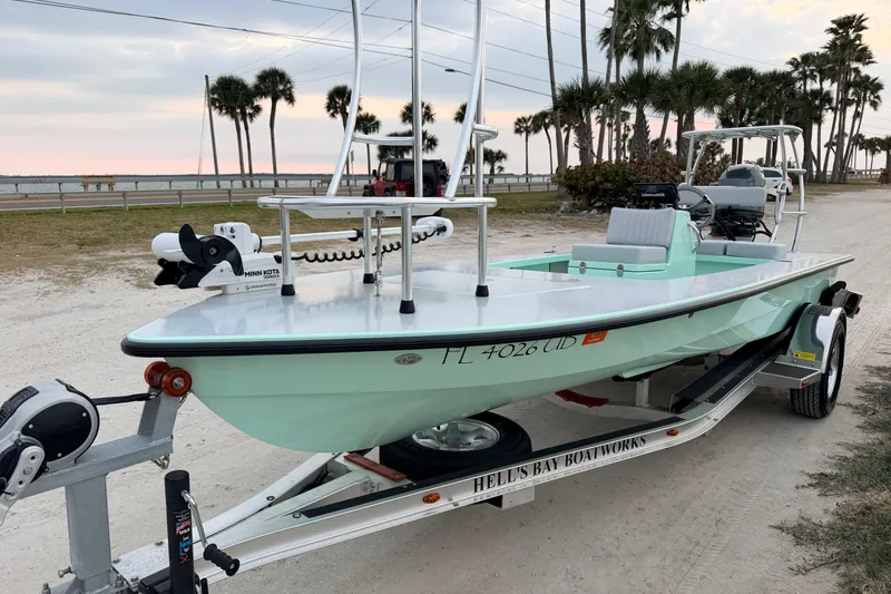 Slide: The Image of 2025 Hell's Bay Professional boat on trailer, parked near beach with palm trees. - 4