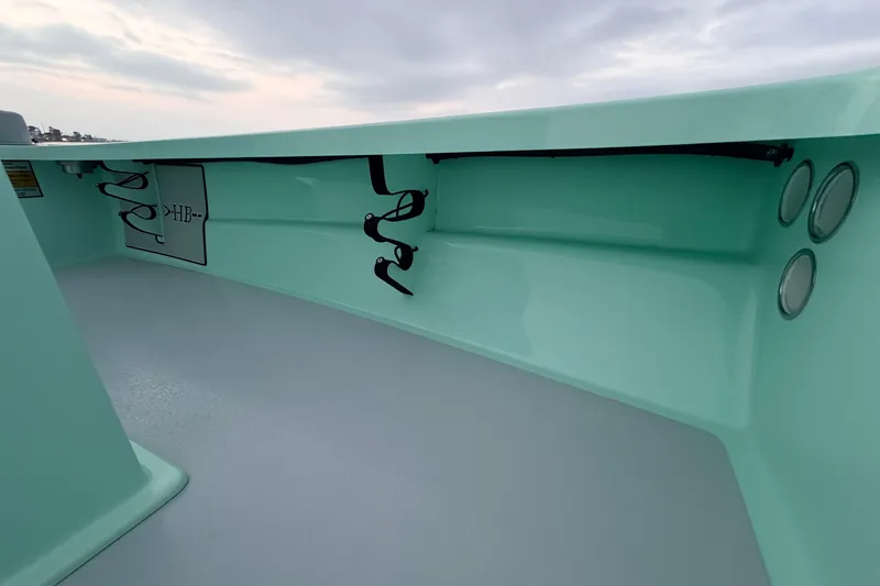 Slide: The Image of 2025 Hell's Bay Professional boat interior with mint green finish and storage compartments. - 40