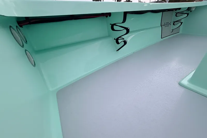 Slide: The Image of 2025 Hell's Bay Professional boat interior with sleek mint green finish and organized wiring. - 41