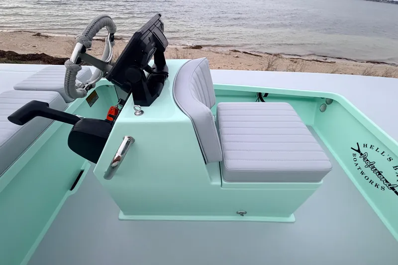 Slide: The Image of 2025 Hell's Bay Professional boat interior with steering console and cushioned seat. - 43