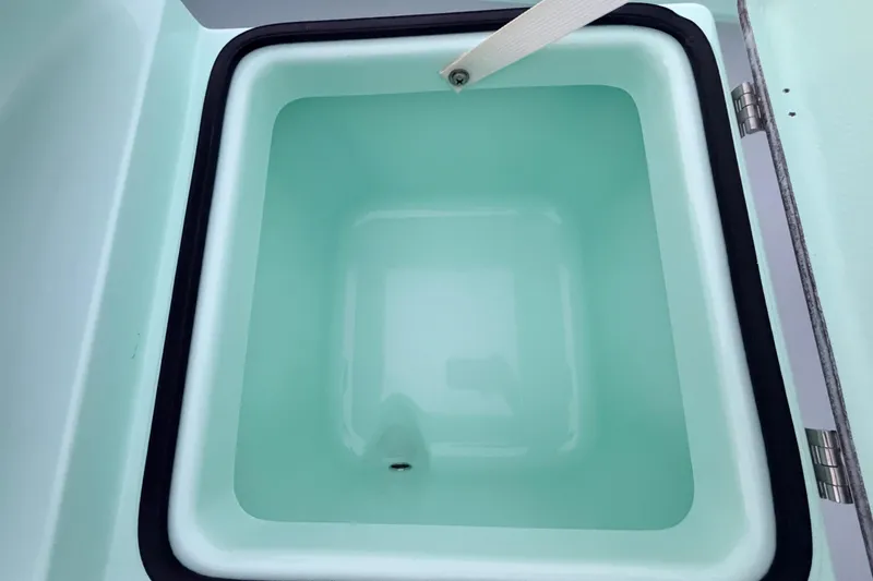 Slide: The Image of 2025 Hell's Bay Professional boat compartment with open lid, showcasing interior design. - 45