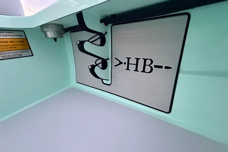 Slide: The Image of 2025 Hell's Bay Professional boat interior with logo and capacity label. - 46