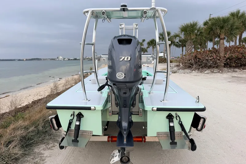 Slide: The Image of 2025 Hell's Bay Professional boat with Yamaha 70 engine on a sandy beach. - 5