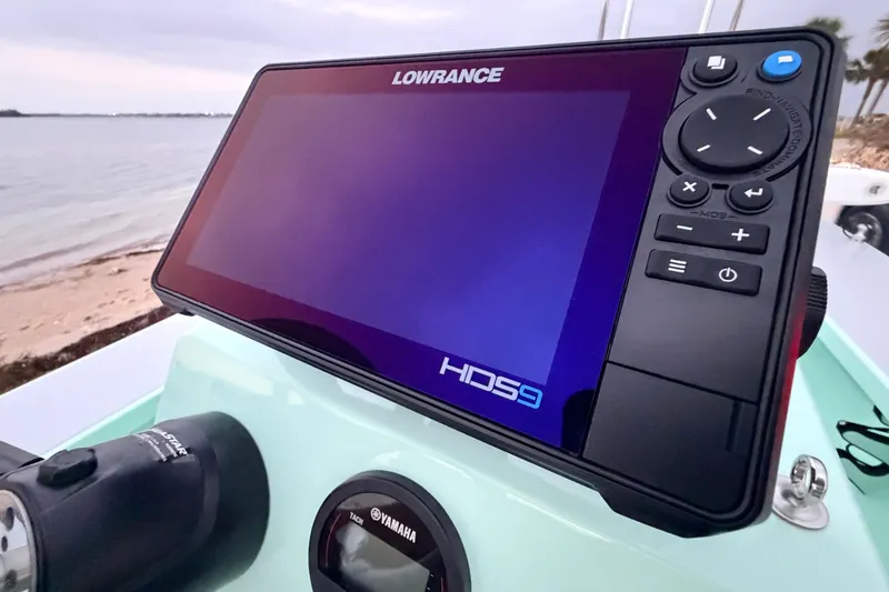 Slide: The Image of Lowrance HDS9 display on 2025 Hell's Bay Professional boat, near a sandy shoreline. - 51