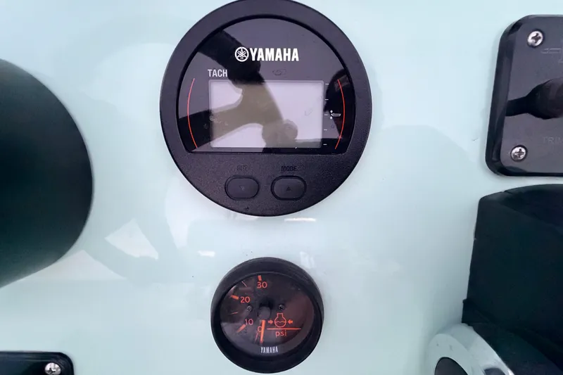 Slide: The Image of Yamaha tachometer and pressure gauge on 2025 Hell's Bay Professional boat dashboard. - 53