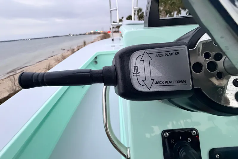 Slide: The Image of 2025 Hell's Bay Professional boat jack plate control by the shoreline. - 56