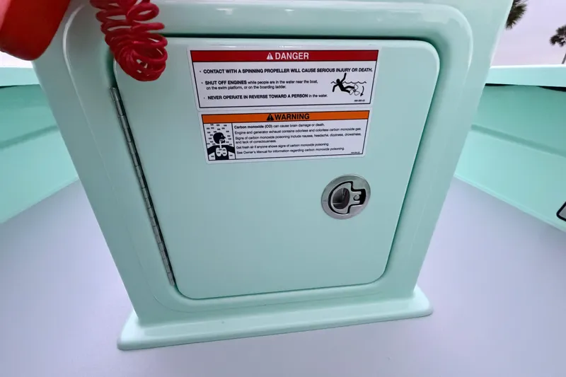 Slide: The Image of 2025 Hell's Bay Professional boat warning label on light green panel with safety instructions. - 57