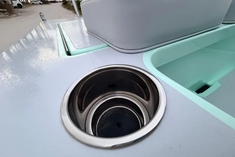 Slide: The Image of 2025 Hell's Bay Professional boat deck with cup holder and storage compartment. - 62