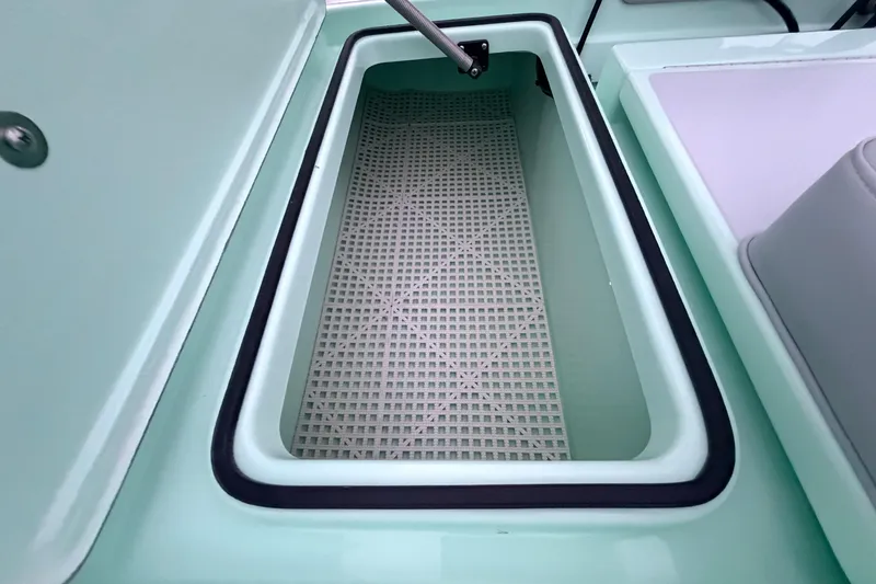 Slide: The Image of 2025 Hell's Bay Professional boat storage compartment with open lid and textured interior. - 65