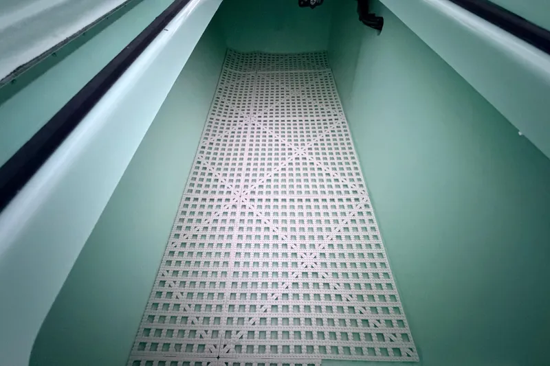 Slide: The Image of Interior view of 2025 Hell's Bay Professional boat with grid-patterned flooring. - 66