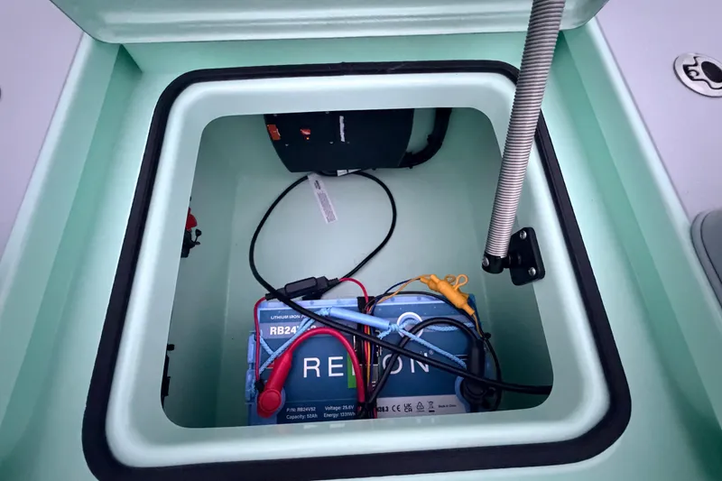 Slide: The Image of Battery compartment of 2025 Hell's Bay Professional boat with lithium-ion battery setup. - 69
