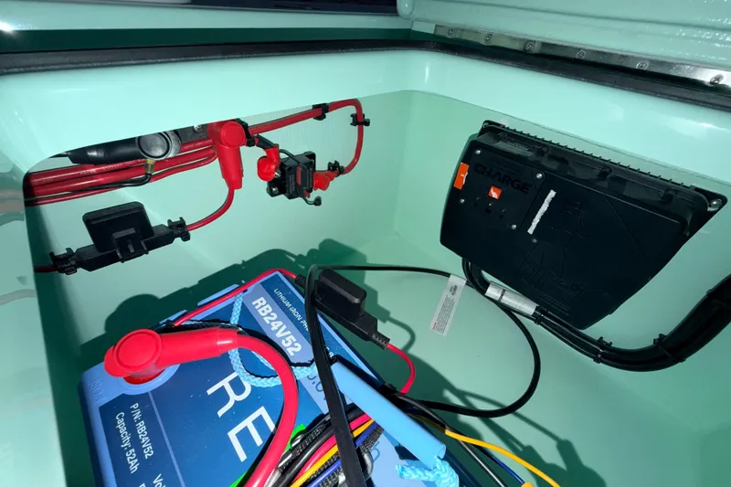 Slide: The Image of Electrical setup in a 2025 Hell's Bay Professional boat, featuring battery and wiring components. - 71