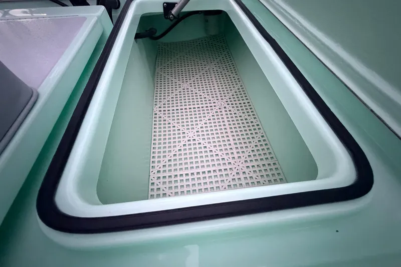 Slide: The Image of Interior view of a 2025 Hell's Bay Professional boat compartment with grid flooring. - 75