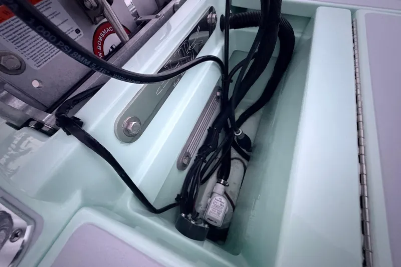 Slide: The Image of 2025 Hell's Bay Professional boat wiring and components in a storage compartment. - 78