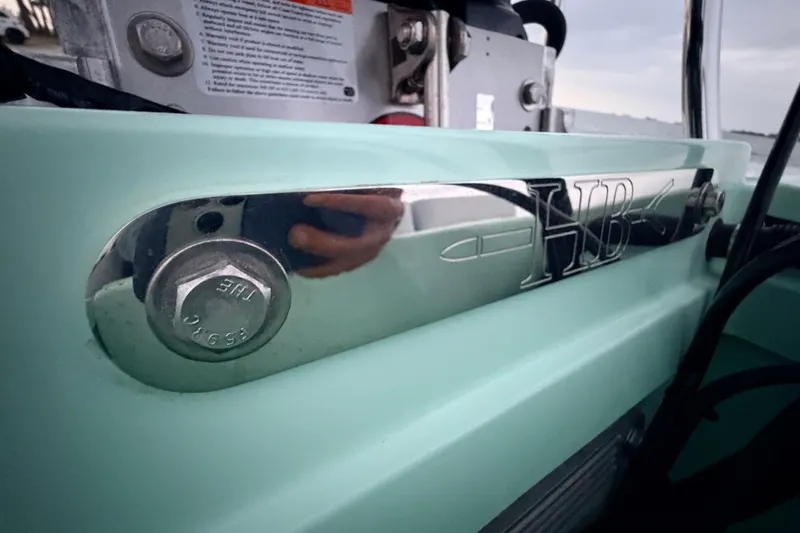Slide: The Image of Close-up of 2025 Hell's Bay Professional boat detail with HB logo and bolt. - 79