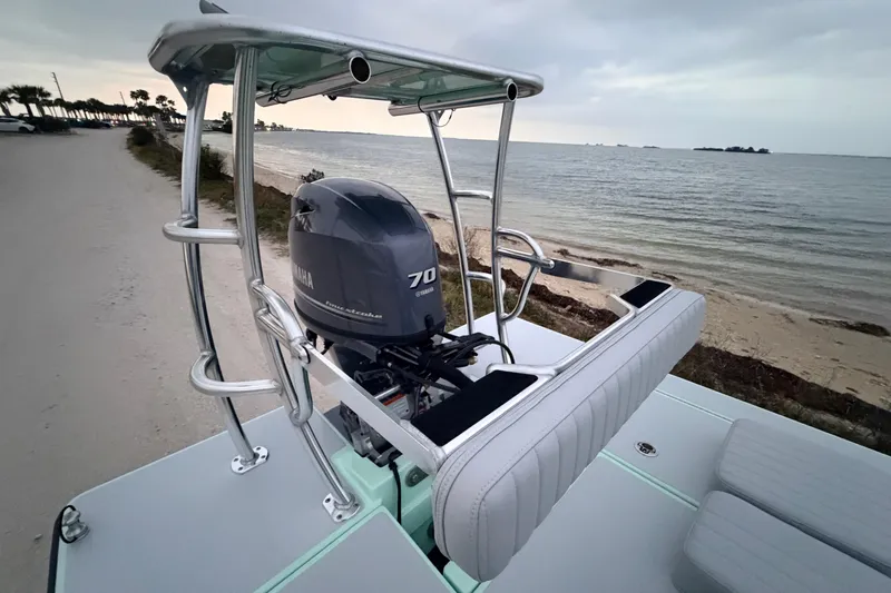 Slide: The Image of 2025 Hell's Bay Professional boat with Yamaha 70 engine by the shoreline. - 83