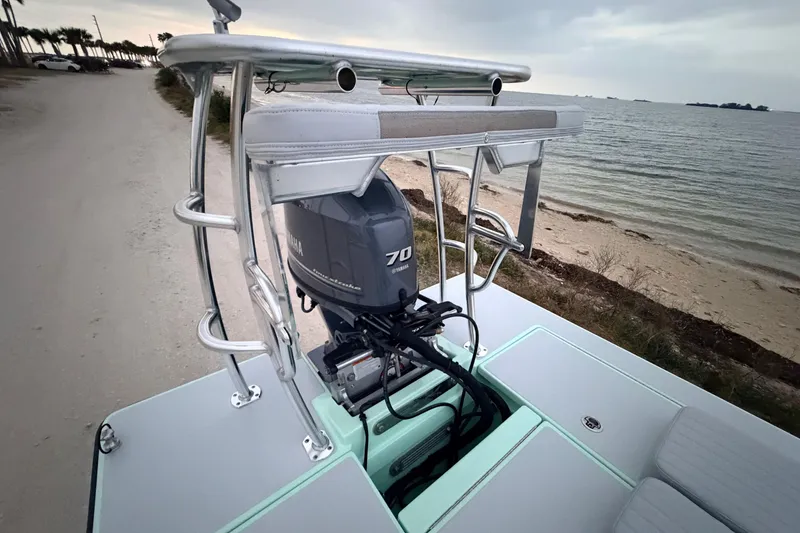Slide: The Image of 2025 Hell's Bay Professional boat with Yamaha 70 engine, parked by the beach. - 85