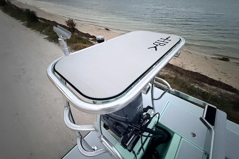 Slide: The Image of 2025 Hell's Bay Professional boat console with coastal backdrop, featuring sleek design and modern equipment. - 86