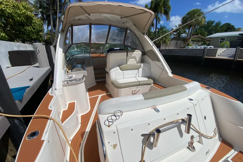 Slide: The Image of 2007 Sea Ray Sundancer 310 boat docked, featuring spacious seating and sleek design. - 29