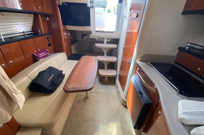 Slide: The Image of Interior of 2007 Sea Ray Sundancer 310 yacht with seating, table, and kitchenette. - 36