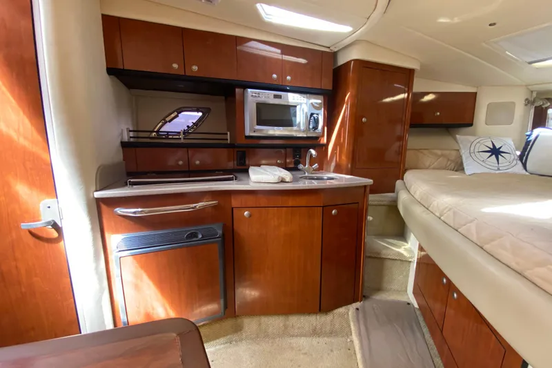 Slide: The Image of Interior of 2007 Sea Ray Sundancer 310 yacht with kitchenette and cozy seating area. - 37
