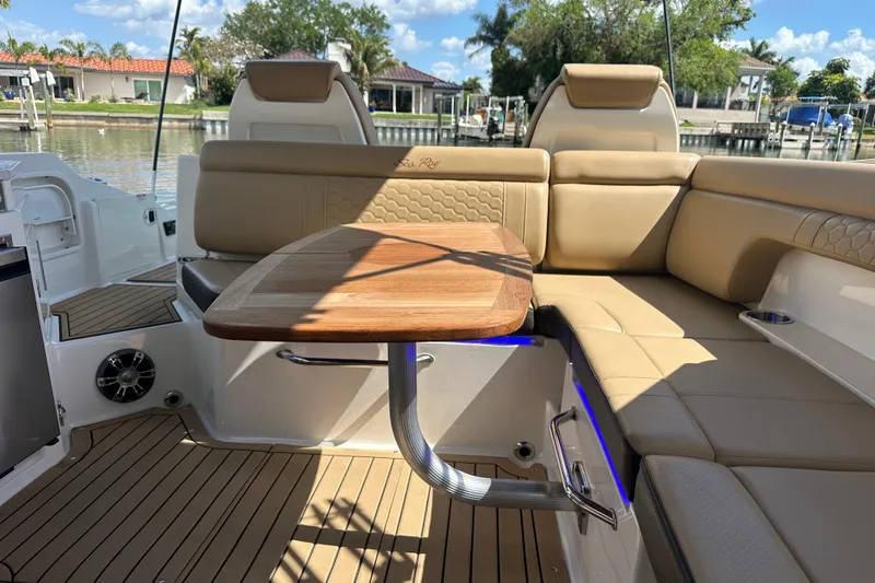 Slide: The Image of Luxurious 2022 Sea Ray SDX 290 boat interior with elegant seating and wooden table. - 15