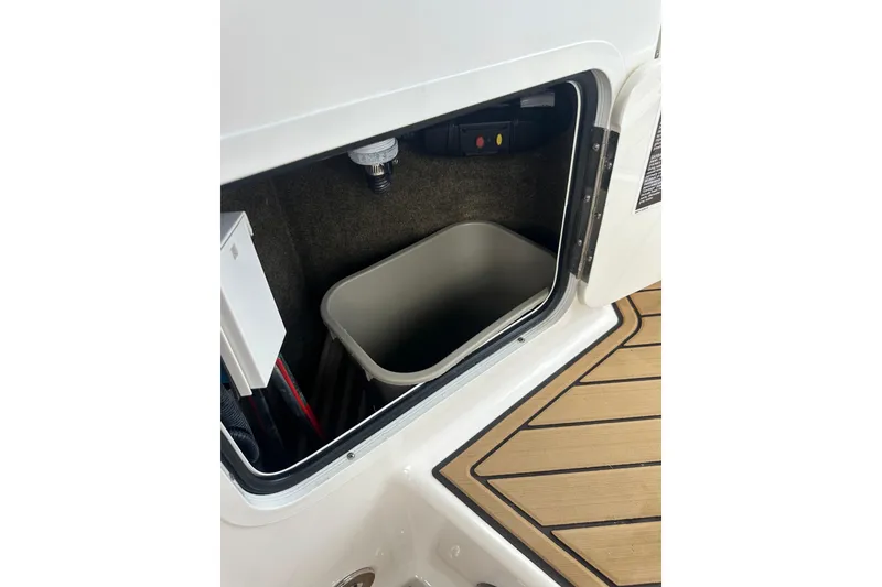Slide: The Image of Storage compartment on 2022 Sea Ray SDX 290 boat, featuring a built-in container. - 16