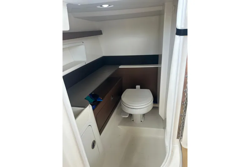 Slide: The Image of 2022 Sea Ray SDX 290 boat interior bathroom with toilet and storage. - 5
