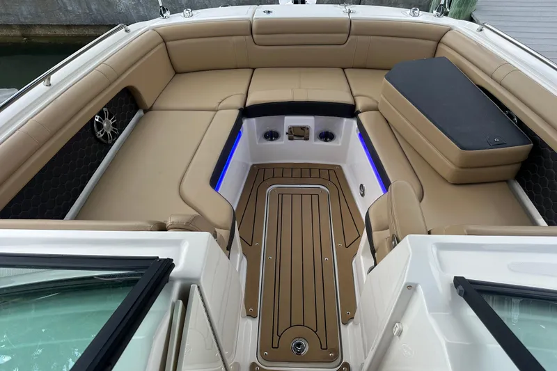 Slide: The Image of Luxurious 2022 Sea Ray SDX 290 boat interior with tan seating and wood flooring. - 7