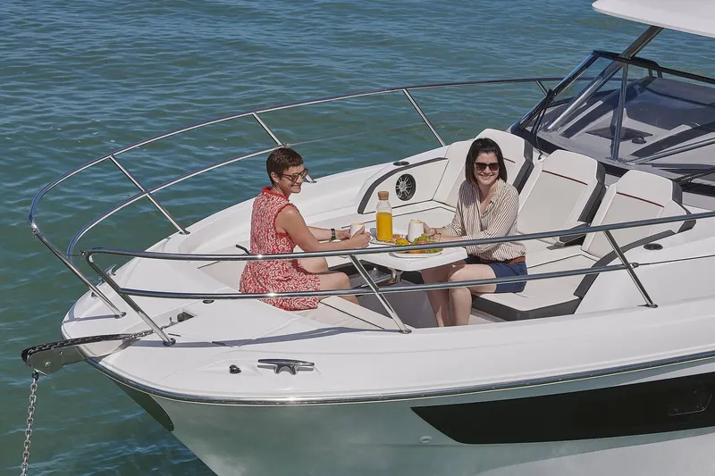 Slide: The Image of Two women relaxing on Jeanneau Leader 12.5, 2024 model. - 11