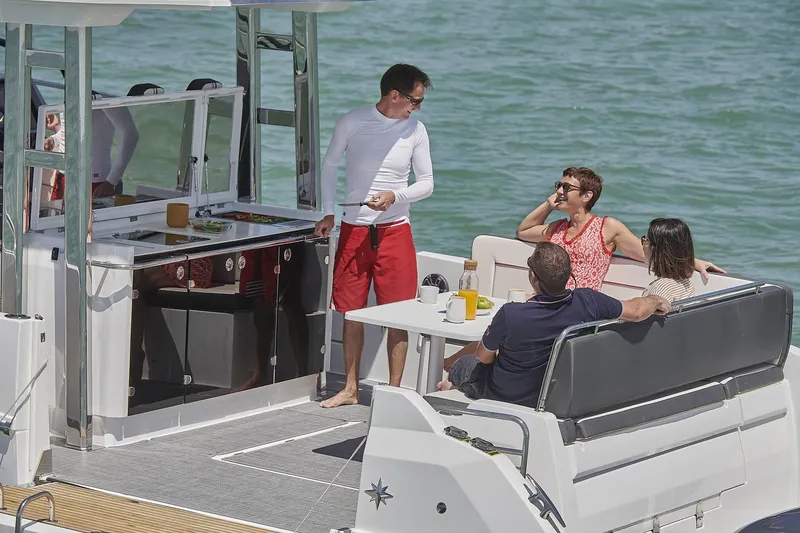 Slide: The Image of People relaxing on Jeanneau Leader 12.5 yacht, 2024 model. - 13