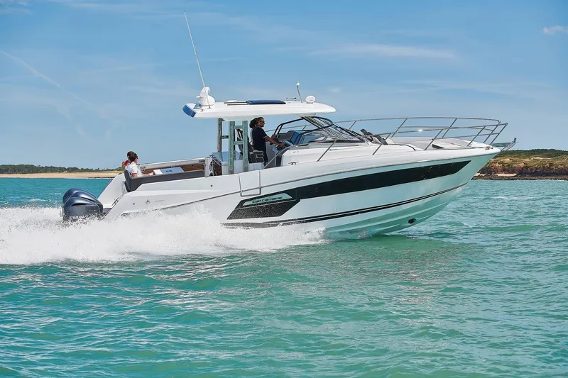 Slide: The Image of 2024 Jeanneau Leader 12.5 motorboat cruising on water. - 14