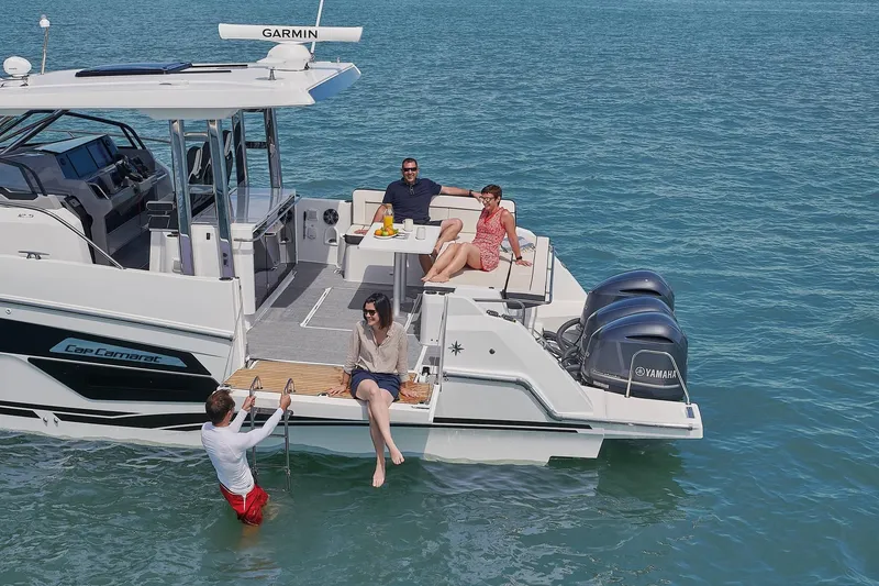 Slide: The Image of 2024 Jeanneau Leader 12.5 yacht on water with people onboard. - 15