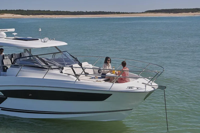 Slide: The Image of 2024 Jeanneau Leader 12.5 yacht on calm waters with two people onboard. - 16