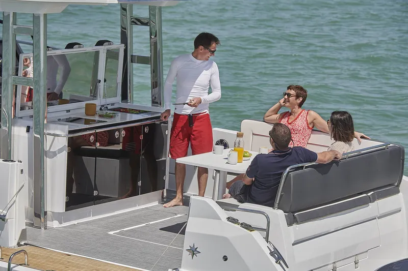 Slide: The Image of People relaxing on Jeanneau Leader 12.5 yacht, 2024 model. - 20