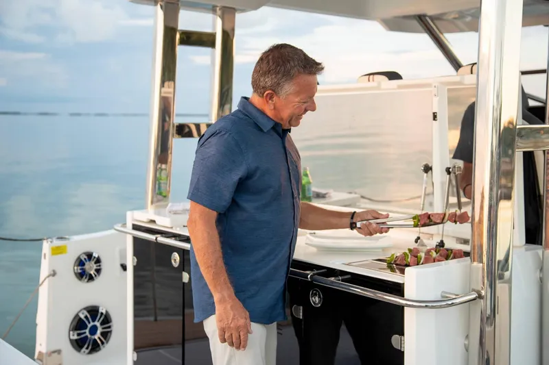 Slide: The Image of Man grilling on Jeanneau Leader 12.5 yacht, 2024 model. - 4