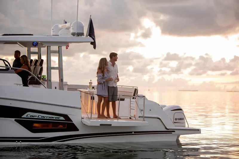 Slide: The Image of Couple enjoying sunset on Jeanneau Leader 12.5, 2024 model. - 9