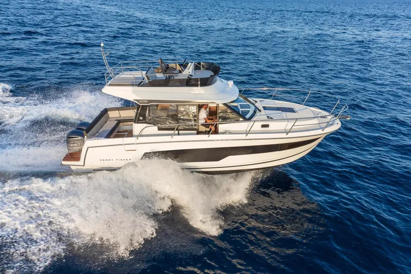 Slide: The Image of Jeanneau NC 1095 Fly 2026 cruising on open sea, luxury motorboat. - 3