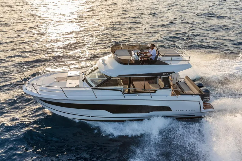 Slide: The Image of Jeanneau NC 1095 Fly 2026 cruising on the sea at sunset. - 4