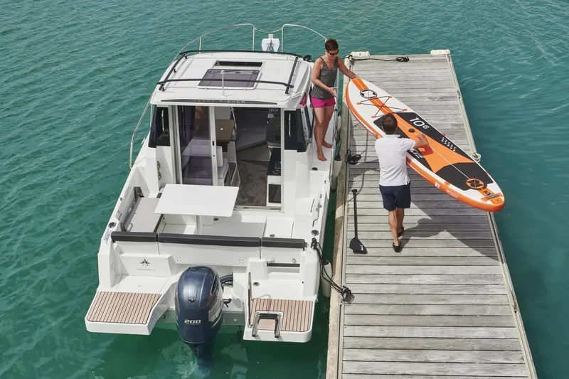 Slide: The Image of Jeanneau NC 795 Series 2, 2025, docked with paddleboard. - 23