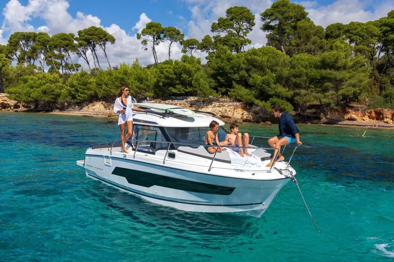 Slide: The Image of Jeanneau NC 795 Series 2 boat 2025 on clear water with passengers. - 3