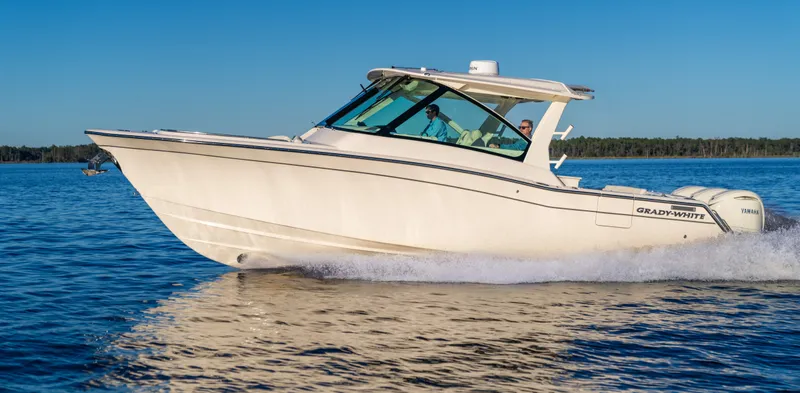 The Image of A 2026 Grady-White Freedom 345 boat speeding across calm water. - 1