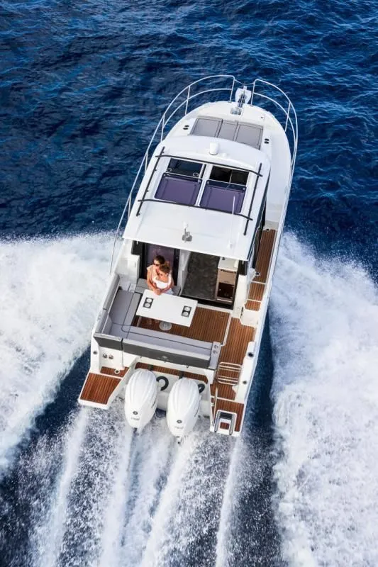 Slide: The Image of Jeanneau NC 895 S2 2026 cruising on open sea, aerial view. - 14