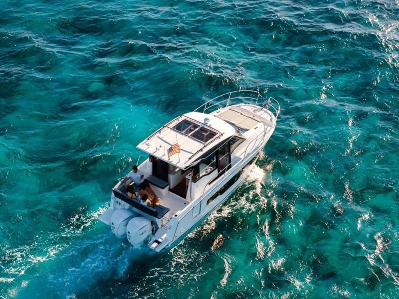 Slide: The Image of Jeanneau NC 895 S2 2026 cruising on turquoise waters. - 25