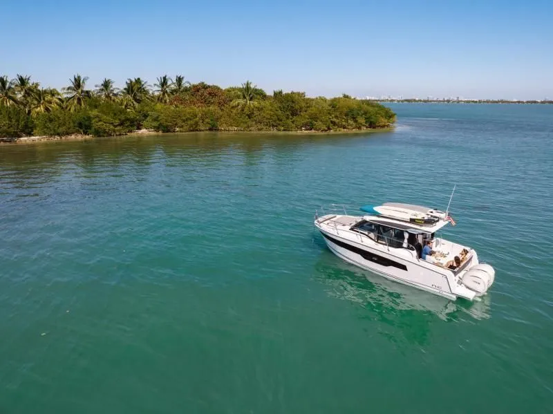 Slide: The Image of Jeanneau NC 895 S2 2026 on calm waters near an island. - 3