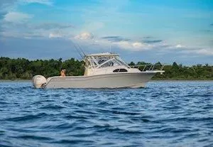 Slide: The Image of 2026 Grady-White Marlin 300 boat on calm waters. - 5